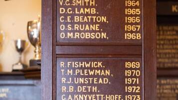 A wooden plaque listing names and years, likely indicating a historical record or awards.