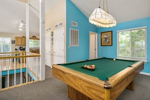 A pool table in a room with blue walls, a wooden ceiling, and a staircase. - The Lookout (Dog-Friendly) (Smithville)