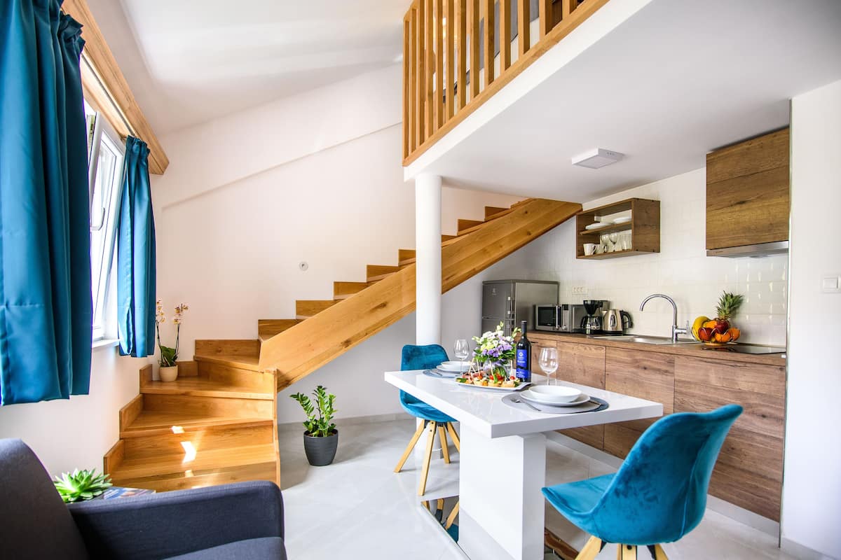 Studiosuite – deluxe, bassengutsikt | Oppholdsområde | En 120-centimeters Flatskjerm-TV med Parabol-TV samt LED-TV