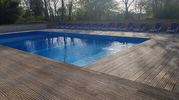 Seasonal outdoor pool, open 10:00 AM to 9:00 PM, pool umbrellas