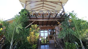 A covered outdoor area with a wooden structure and a glass door leading inside. - Nyange Resort and Marina (Entebbe)