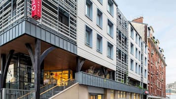 A modern building with a prominent red sign for the Abarthotel.