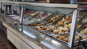 A buffet counter with various food items like pastries and sandwiches. - Hotel Chalé São Jorge (Aparecida)