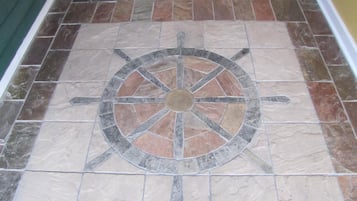 A floor with a circular design featuring a compass rose.