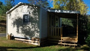 A small, single-story cabin with a porch and a window.