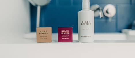 Three Helen Berger products: a natural soap, a natural soap, and a body lotion.