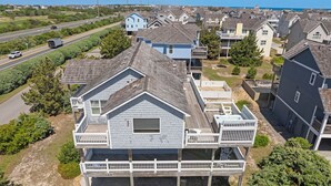 A coastal residential area with houses featuring gabled roofs and wooden decks.