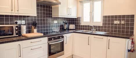 Dukes Cabin One Bedroom Apartment | Private kitchen | Full-sized fridge, microwave, oven, stovetop