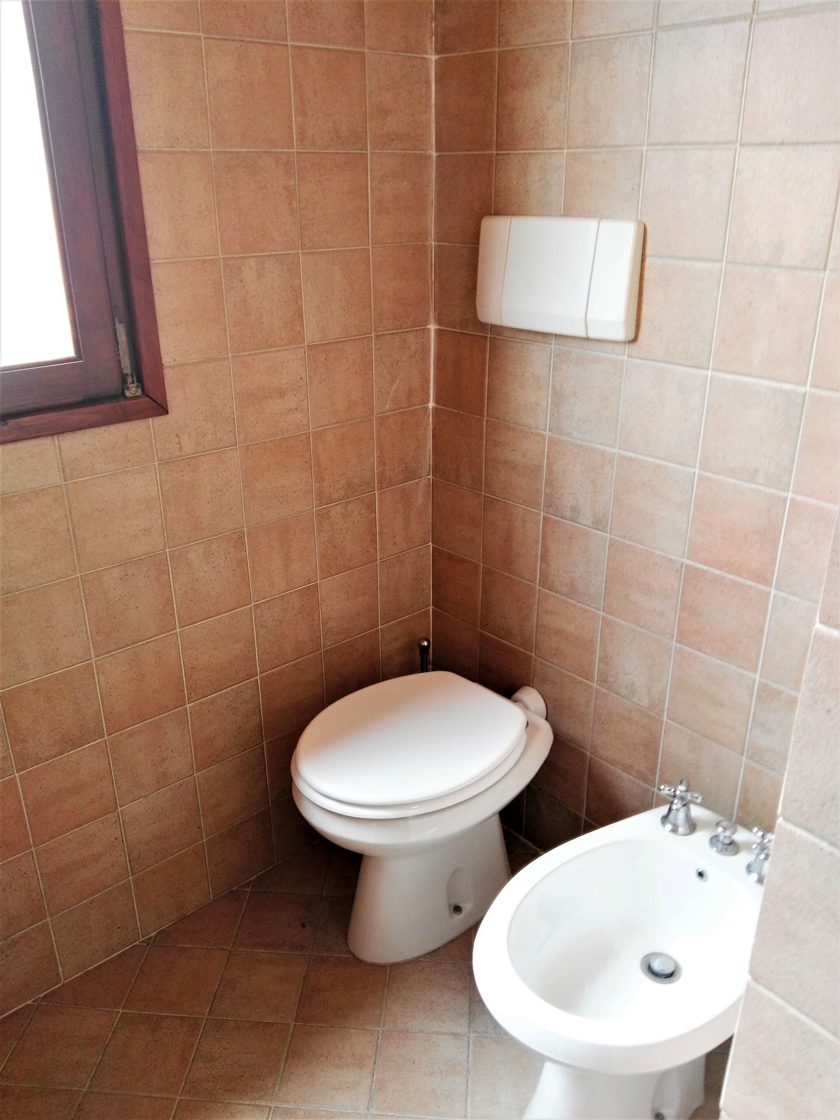 A small bathroom with a toilet and a sink.