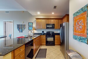 Enjoy cooking and dining in this well-equipped kitchen with a large island, sink, and seating area.