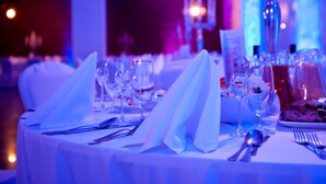 A table set for dining with white tablecloths, glassware, and a dessert plate. - Hotel Warmia Spa (Braniewo)