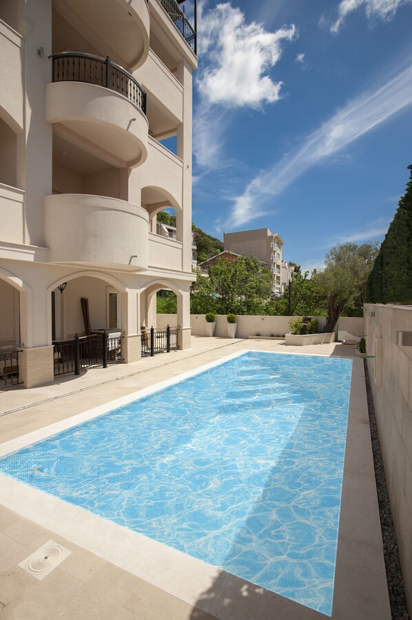 Seasonal outdoor pool, open 9:00 AM to 8:00 PM, pool umbrellas