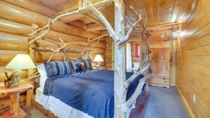 A log cabin bedroom with a four-poster bed, two bedside lamps, and a rustic wooden ceiling. - LeConte - 2BR/New Hot Tub/New Firepit/Grill/Sleeps 8 (Gatlinburg)