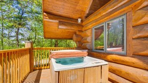 A wooden cabin with a hot tub on the deck, surrounded by trees. - LeConte - 2BR/New Hot Tub/New Firepit/Grill/Sleeps 8 (Gatlinburg)