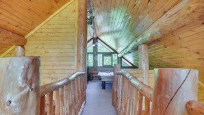 A wooden interior with a central corridor leading to a seating area. - LeConte - 2BR/New Hot Tub/New Firepit/Grill/Sleeps 8 (Gatlinburg)