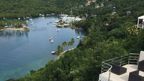 A swimming pool with a view of a marina and surrounding greenery. - Famous Marigot Bay Ridge - Safe - Architect 2 bed - Amazing Caribbean views (Marigot Bay)