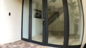 A sliding glass door leading to a staircase. - Huge House in Fort Lauderdale -  821 (Fort Lauderdale)