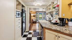 A kitchen with a black refrigerator, a coffee maker, and a sink. - Night Owl - Murphys Vacation Rentals (Murphys)