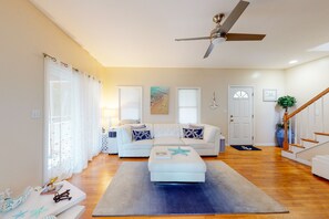 Relax in this stylish living room with a large sofa, ottoman, and abstract art.