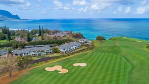 A golf course with a view of the ocean and mountains in the background. - Relaxing Princeville Retreat • Golf Course + Sunset Views • A/C & Pool (Princeville)