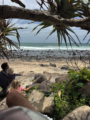 A rocky beach with a view of the ocean.