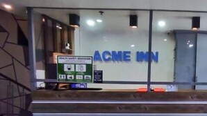 A reception desk with a sign reading "ACME INN" and a health safety reminders poster. - ACME Inn Subic (Olongapo)