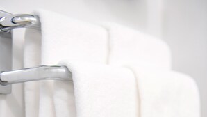 A white towel hanging on a metallic towel rack. - Hotel Trend MikawaAnjo (Anjo)