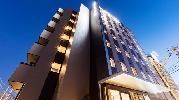 A modern hotel with a prominent vertical design, large windows, and a well-lit entrance. - Hotel Trend MikawaAnjo (Anjo)