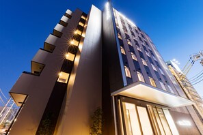 A modern hotel with a prominent vertical design, large windows, and a well-lit entrance. - Hotel Trend MikawaAnjo (Anjo)