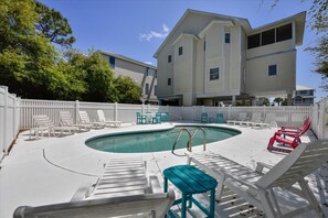 A pool area with lounge chairs and a swimming pool. - A MEMORY OF A LIFETIME is what you will have when you stay at this beautiful Plantation home (St. George Island)