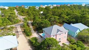 A coastal residential area with multiple houses, a clear road, and a swimming pool. - ATTITUDE ADJUSTER IS THE PERFECT FAMILY GETAWAY! (St. George Island)