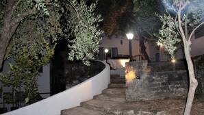A stone staircase leading to a building with a white exterior and a small garden area with olive trees. - PioppiHouse Casa Vacanza.  Large independent suite with small terrace overlooking the sea (Acciaroli)