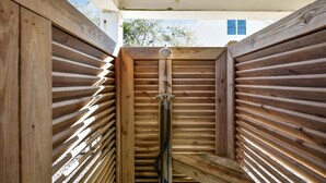 Una struttura in legno con listelli orizzontali, probabilmente una sauna o struttura simile.