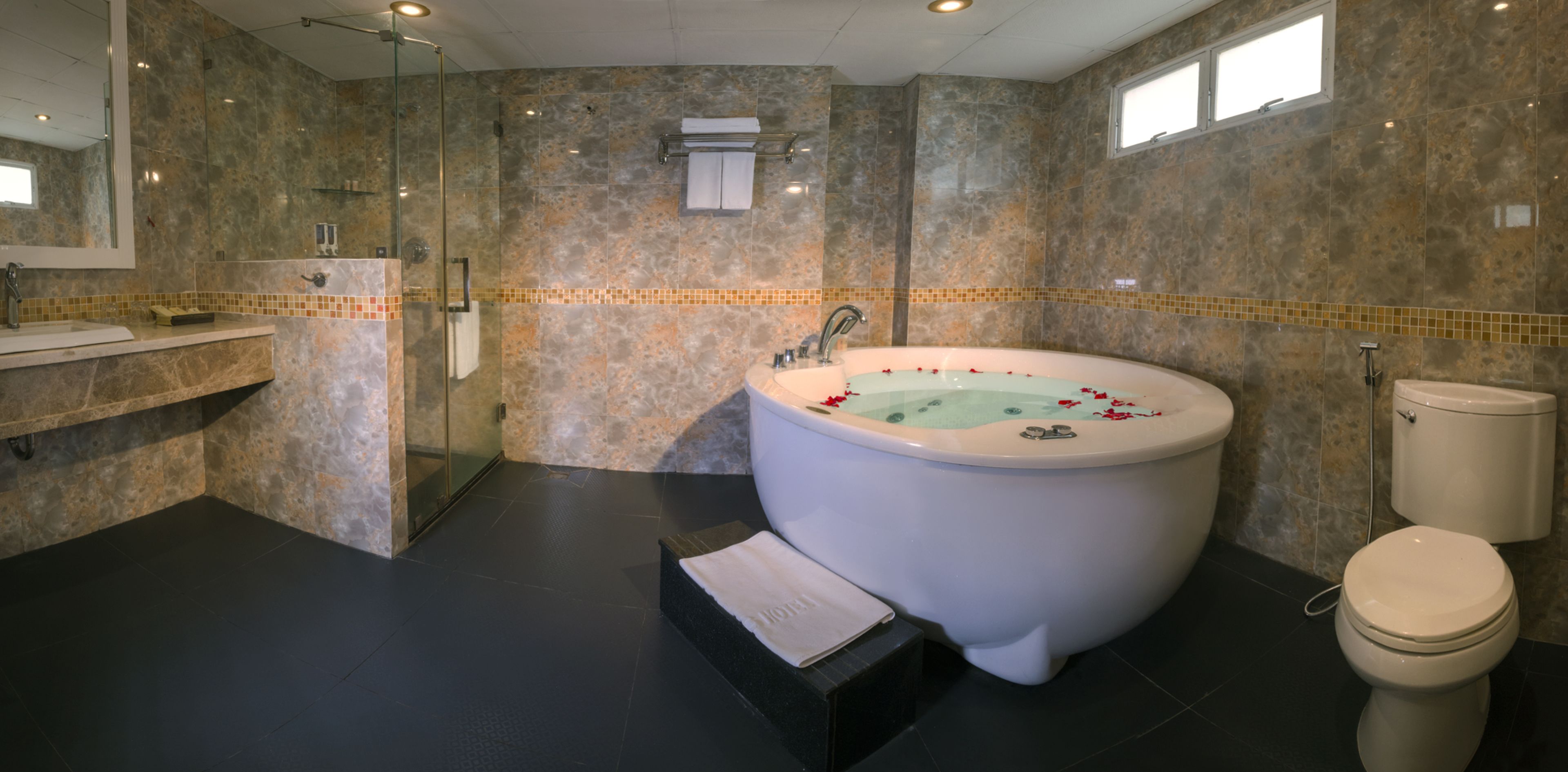 king suite | bathroom | bathtub, free toiletries, hair dryer, slippers