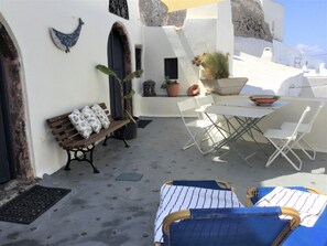 Outdoor dining - House of the Angels. An old Winery renovated and transformed into a cosy house (Santorini - Oia)