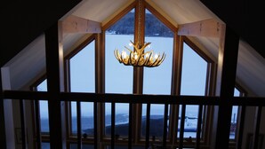 A room with a wooden ceiling and a chandelier. - Lakefront Retreat on Lake Flower near Lake Placid (Saranac Lake)