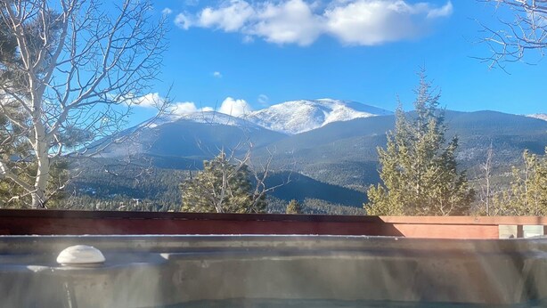 A hot tub with a mountain view.