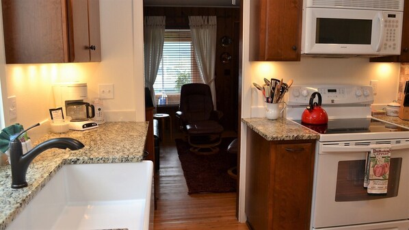 A compact kitchen with a microwave, stove, and sink. - 2Bd/2Ba New Kitchen, New Baths, Close To The Beach, Back Deck for Relaxation (Seaside)