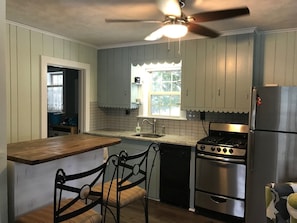 Enjoy meals in the kitchen with a stove, oven, and refrigerator, and dine at the table with two chairs.