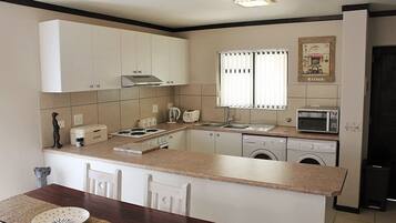 Family Apartment, Non Smoking, Pool Access | Private kitchen | Full-size fridge, microwave, oven, stovetop