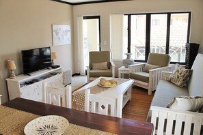 Family Apartment, Non Smoking, Pool Access | Living area | 40-inch Smart TV with satellite channels, TV, Netflix - Santini Village 74 (Plettenberg Bay)