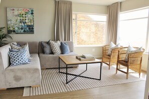 Design Apartment, 1 Bedroom, Non Smoking, Partial Sea View | Living area | Flat-screen TV