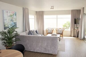 Design Apartment, 1 Bedroom, Non Smoking, Partial Sea View | Living area | Flat-screen TV