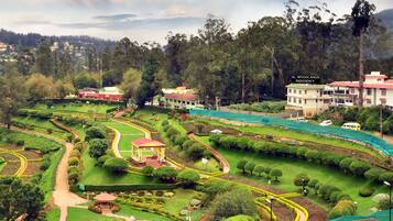 A residential area with a park, a gazebo, and a large building labeled "WOODLANDS RESIDENCY".