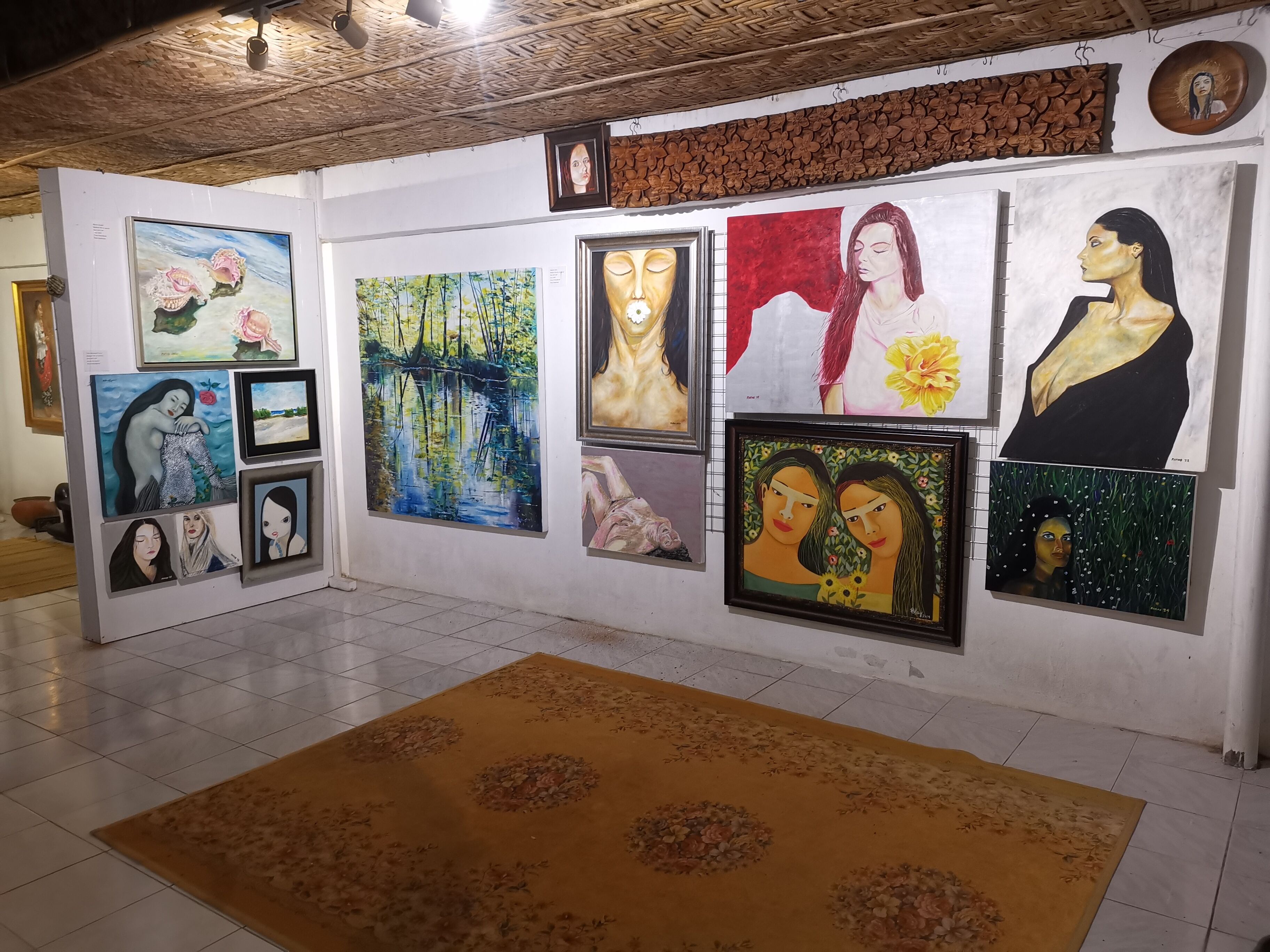 A gallery with various artworks displayed on the walls.