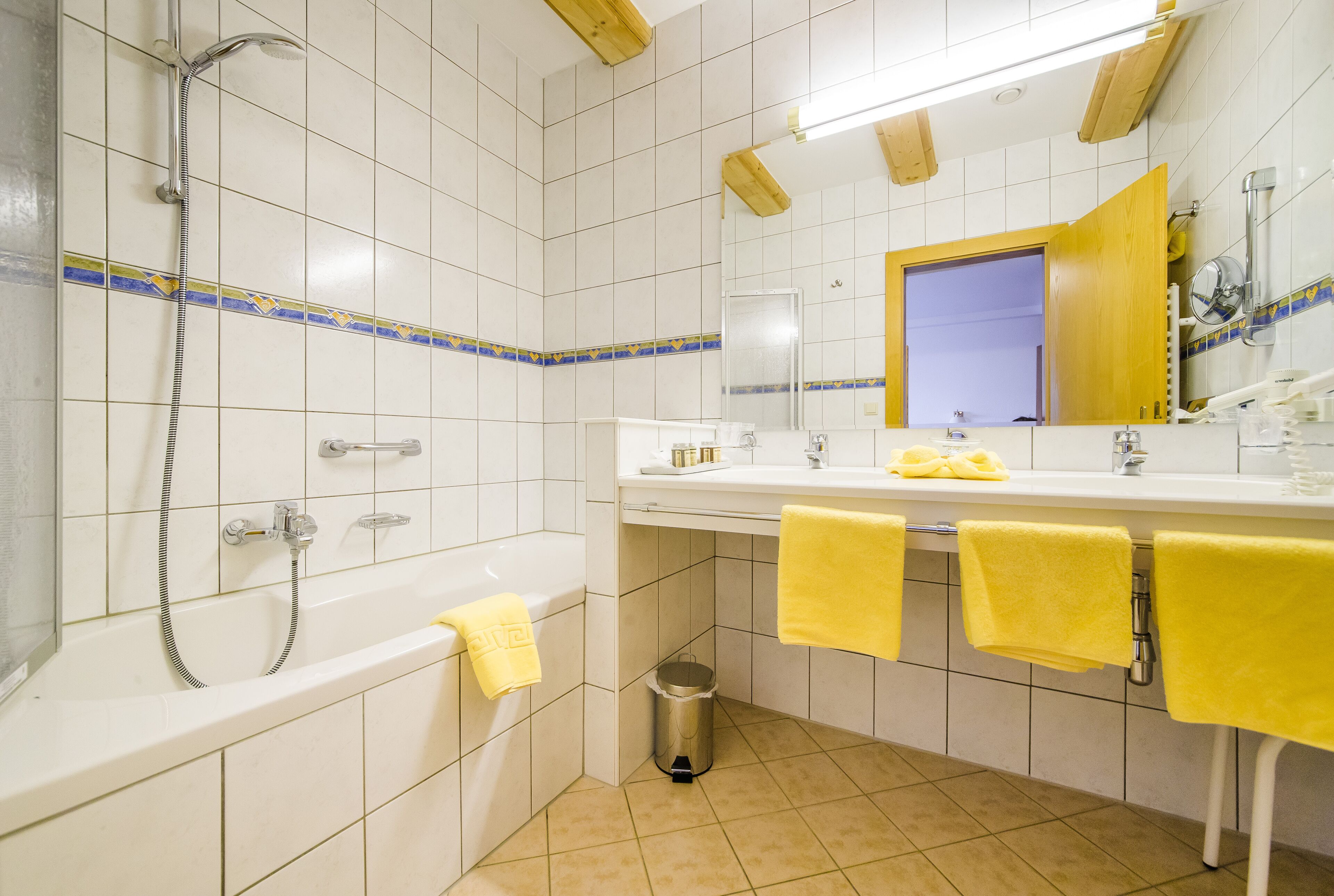 A bathroom with a bathtub, shower, and sink.