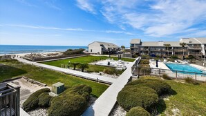 A resort with a pool, beach access, and a view of the ocean.