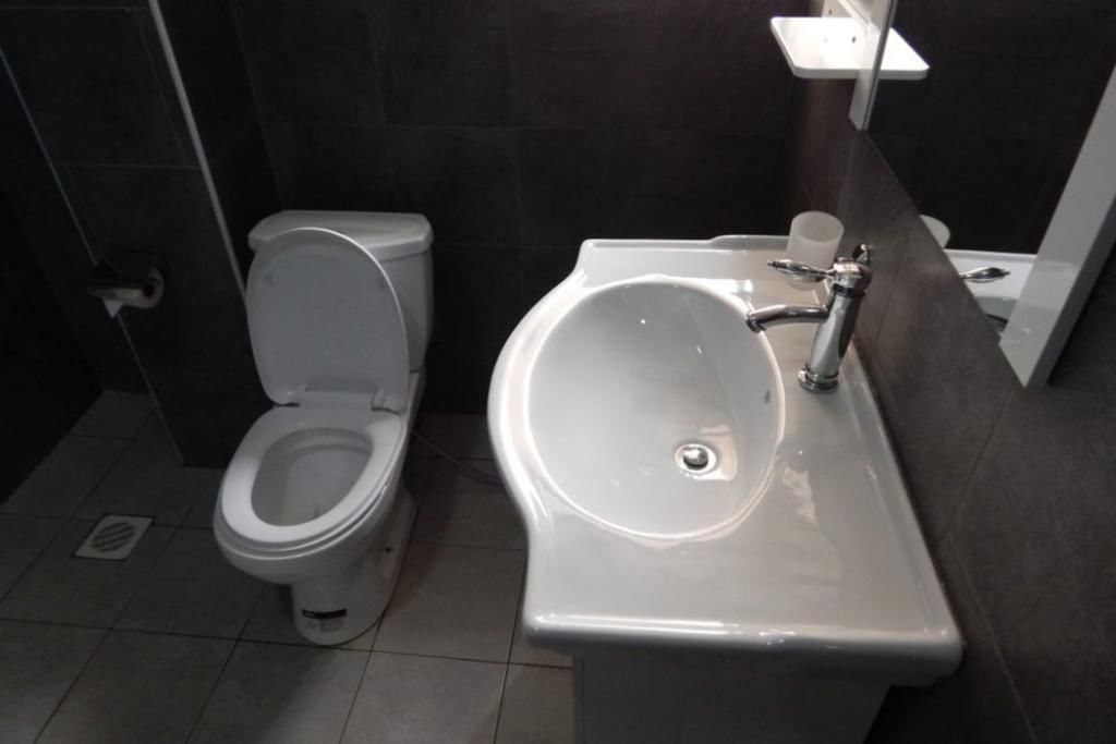 A modern bathroom with a toilet and a sink.