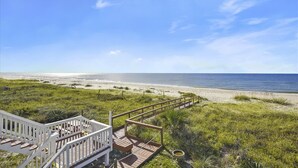 A wooden deck with a white railing leading to a beach view. - YOU WILL INDEED be on Cloud Nine when you stay in this beautiful, beachfront home. (St. George Island)