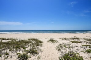 A beach with a clear sky and ocean in the background. - Cozy Cabanas East. A newly renovated ground level duplex. (St. George Island)